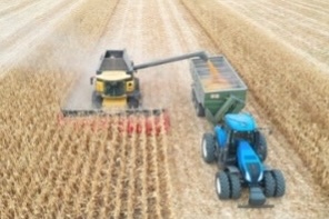 A small image of a farm combine, tracor and trailer