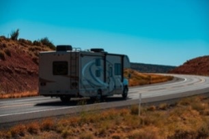 A small image of an RV on the road