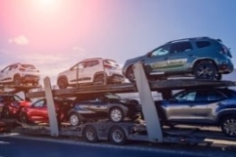 A small image of a trailer loaded with cars